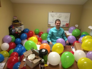 It's me, Alex, in a sea of surprise birthday balloons!