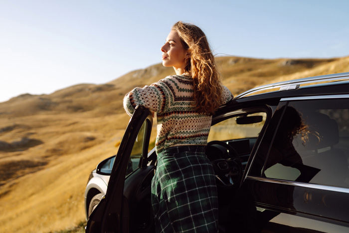 woman standing near car