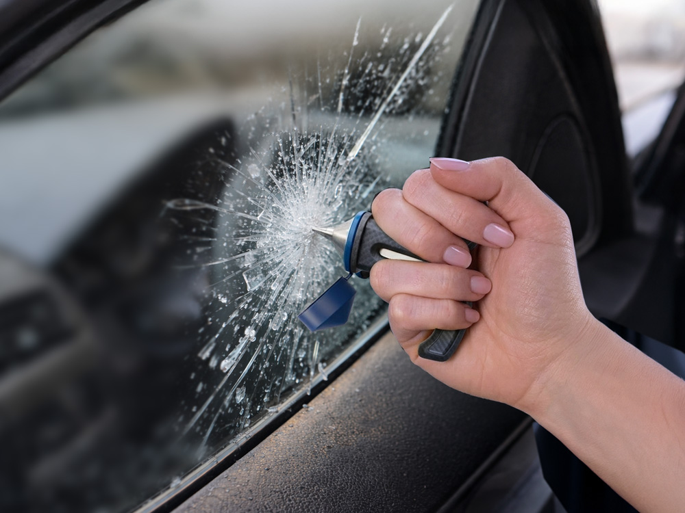 breaking window glass with tool