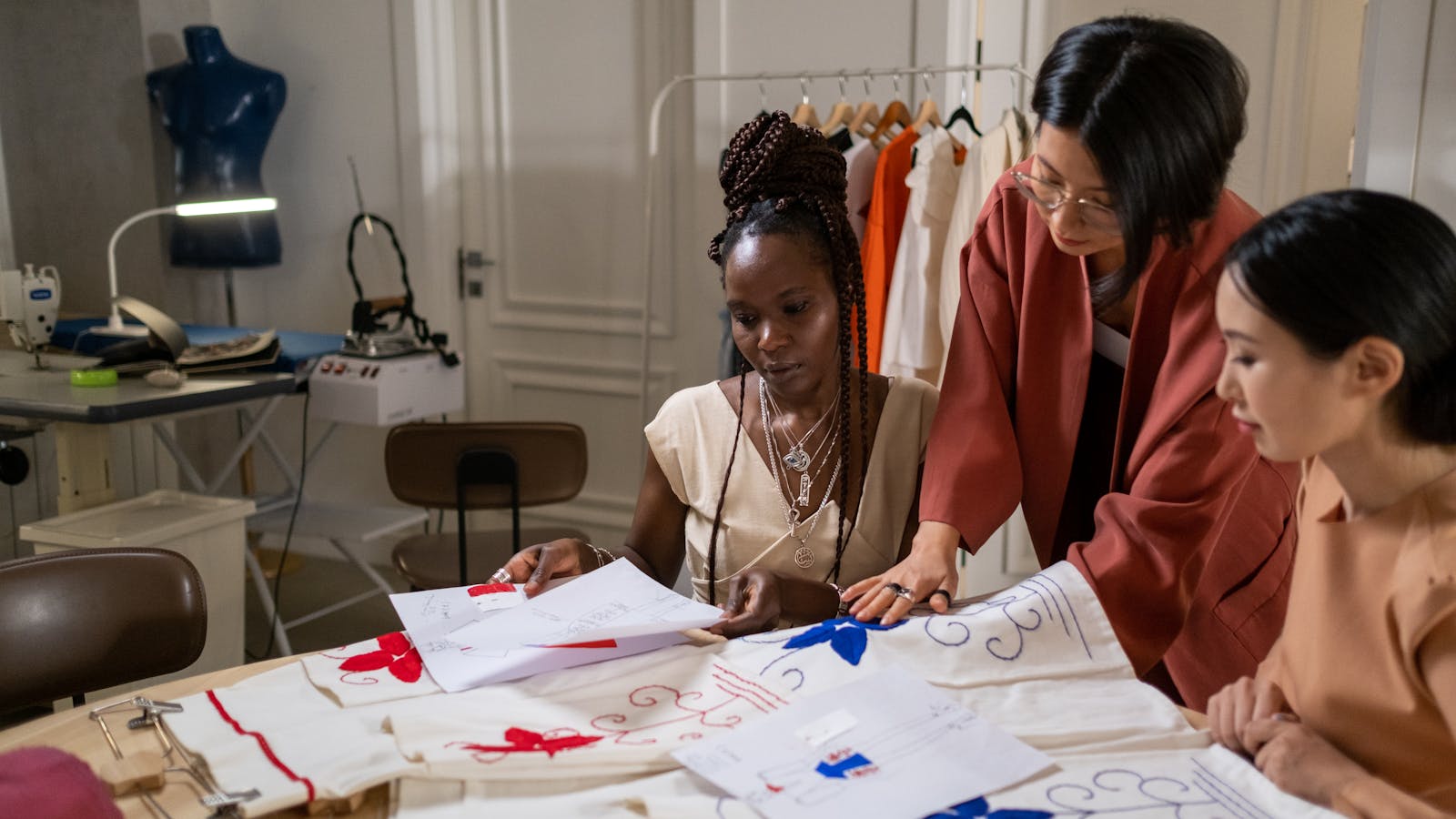 Designer and engineer reviewing product drawings together