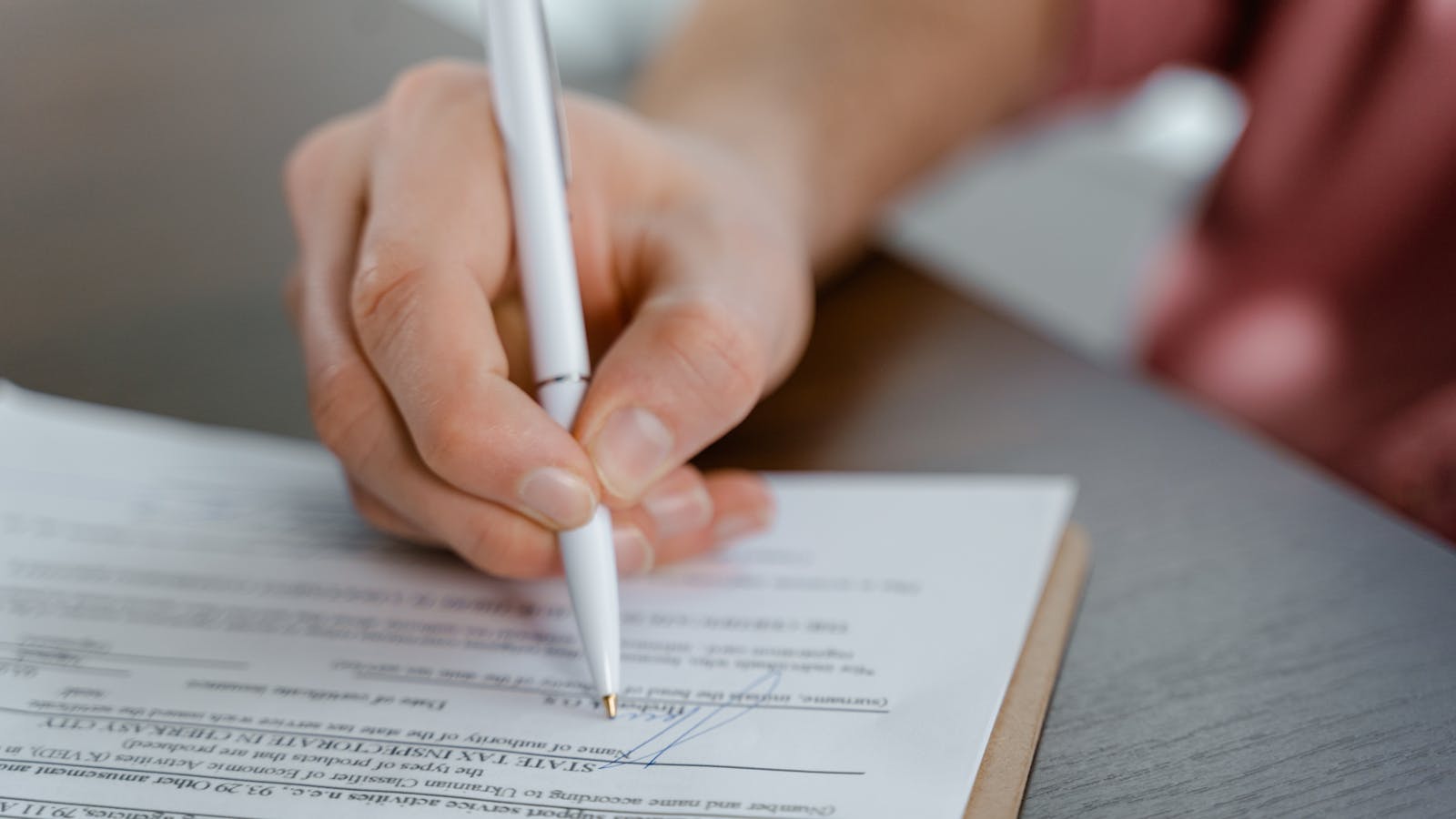 Close-up of a contract document with a pen resting on it